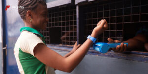 Girl paying with VeryPay bracelet
