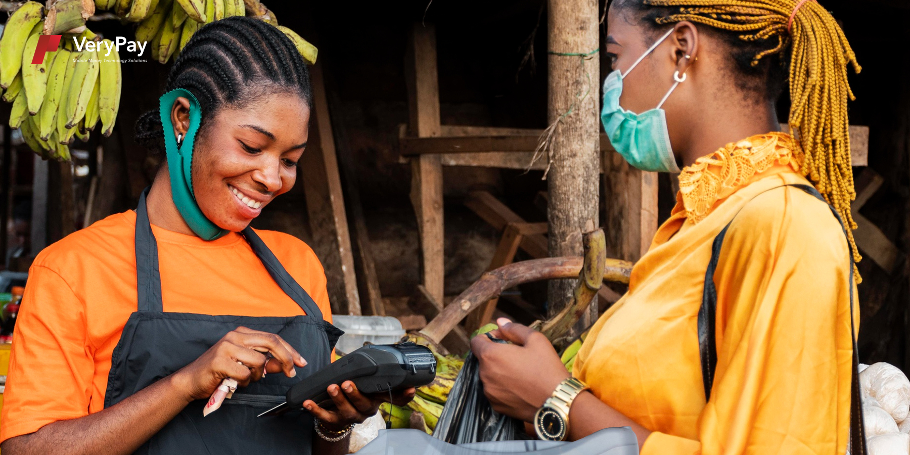 Two women transacting with a PoS device